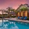 Gorgeous poolside with palm trees and a sunset